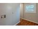 Laundry room featuring wood look floors, bright lighting, and a window at 2245 Dauphine St, Atlanta, GA 30344