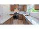 Modern kitchen featuring granite countertops, stainless steel appliances, and wood look floors at 334 Bloomfield Cir, Canton, GA 30114