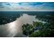 Stunning aerial view of the lake surrounded by lush forests and lakefront properties at 3795 Newport Bay Dr, Alpharetta, GA 30005