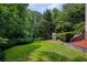 Expansive backyard featuring lush green lawn and mature trees, perfect for outdoor activities at 3795 Newport Bay Dr, Alpharetta, GA 30005