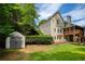 Large backyard featuring a small storage shed and a charming screened-in porch on a two-story home at 3795 Newport Bay Dr, Alpharetta, GA 30005