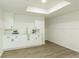Basement bar features light wood-look flooring and white cabinetry, ideal for entertaining at 3795 Newport Bay Dr, Alpharetta, GA 30005