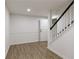 Finished basement boasts wood-look floors, white walls, and stairs with a black railing at 3795 Newport Bay Dr, Alpharetta, GA 30005