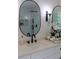 Bathroom vanity with quartz counters, black fixtures, and a decorative oval mirror at 3795 Newport Bay Dr, Alpharetta, GA 30005