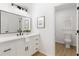 Modern bathroom with white vanity, sleek black hardware, and a glimpse into the toilet room at 3795 Newport Bay Dr, Alpharetta, GA 30005