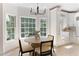 Bright breakfast nook with a round table, woven chairs, and scenic views from the large windows at 3795 Newport Bay Dr, Alpharetta, GA 30005