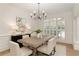 Dining room with wood table, white chairs, and window shutters at 3795 Newport Bay Dr, Alpharetta, GA 30005