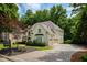 Charming exterior with manicured lawn, complemented by an attached garage and paved driveway at 3795 Newport Bay Dr, Alpharetta, GA 30005