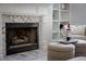Close-up of the fireplace with decorative tile and inviting ambiance, featuring a bottle of wine at 3795 Newport Bay Dr, Alpharetta, GA 30005