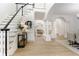 Elegant foyer with hardwood floors, staircase, decorative columns, and an open view to the living room at 3795 Newport Bay Dr, Alpharetta, GA 30005