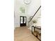 Bright foyer with hardwood floors, black double doors, staircase, and decor setting a welcoming tone at 3795 Newport Bay Dr, Alpharetta, GA 30005