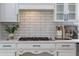 Gas cooktop with white subway tile backsplash and ample upper and lower cabinet space at 3795 Newport Bay Dr, Alpharetta, GA 30005