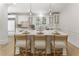 Elegant kitchen island with bar stool seating, quartz countertops, and modern lighting fixtures at 3795 Newport Bay Dr, Alpharetta, GA 30005