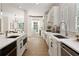 White kitchen featuring an island, breakfast nook, stainless appliances, and arched windows at 3795 Newport Bay Dr, Alpharetta, GA 30005