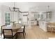 Spacious kitchen with white cabinetry, stainless steel appliances, and an adjacent dining area with seating at 3795 Newport Bay Dr, Alpharetta, GA 30005