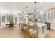 Bright, open kitchen featuring a large island with seating and modern appliances, adjacent to a sunny breakfast nook at 3795 Newport Bay Dr, Alpharetta, GA 30005