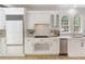 Charming kitchen featuring a stainless steel refrigerator, gas range, and natural light from the arched windows at 3795 Newport Bay Dr, Alpharetta, GA 30005