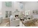 Elegant living room with fireplace, tall windows, and comfortable seating at 3795 Newport Bay Dr, Alpharetta, GA 30005