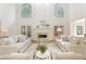 Elegant living room with fireplace, tall windows, and comfortable seating at 3795 Newport Bay Dr, Alpharetta, GA 30005