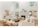Elegant living room with fireplace, tall windows, and comfortable seating at 3795 Newport Bay Dr, Alpharetta, GA 30005