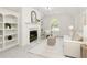 Bright living room with a cozy fireplace, built-in shelves, and neutral decor at 3795 Newport Bay Dr, Alpharetta, GA 30005