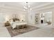 Large main bedroom featuring neutral colors, sitting area, cozy fireplace, and ample natural light at 3795 Newport Bay Dr, Alpharetta, GA 30005