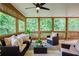 Cozy screened-in porch with comfortable seating and natural views at 3795 Newport Bay Dr, Alpharetta, GA 30005