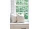 Bright window seat featuring square tile backsplash, neutral pillows, and a scenic outdoor view at 3795 Newport Bay Dr, Alpharetta, GA 30005