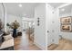 Hallway with wood floors leads to an open living area, offering a seamless transition between spaces at 5120 Token Chase, Cumming, GA 30040