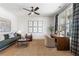 Cozy living room boasts large windows, a ceiling fan, and well-chosen furniture for a comfortable atmosphere at 5120 Token Chase, Cumming, GA 30040