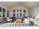 Comfortable covered patio featuring a stylish seating arrangement and neutral color palette with brick accents at 5120 Token Chase, Cumming, GA 30040