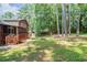 Backyard with lush lawn, mature trees, and access to a screened-in porch at 5207 Shawn Ln, Stone Mountain, GA 30088