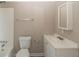 Bathroom with tub, toilet, white vanity and mirror at 5207 Shawn Ln, Stone Mountain, GA 30088