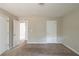 Bedroom featuring neutral carpet, walls, and two closets for ample storage space at 5207 Shawn Ln, Stone Mountain, GA 30088