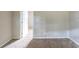 Neutral bedroom with beige carpeting and an open doorway at 5207 Shawn Ln, Stone Mountain, GA 30088