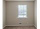 Bedroom featuring neutral carpet, walls, and a window looking out to the front yard at 5207 Shawn Ln, Stone Mountain, GA 30088