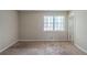 Bedroom with neutral carpet, walls, and a window looking out to the front yard at 5207 Shawn Ln, Stone Mountain, GA 30088