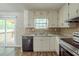 Functional kitchen with white cabinets, modern appliances, and sliding glass door to the patio at 5207 Shawn Ln, Stone Mountain, GA 30088