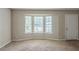 Inviting living room featuring a bay window and neutral carpet at 5207 Shawn Ln, Stone Mountain, GA 30088