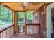 View of a screened in porch with ceiling fan and view of the backyard at 5207 Shawn Ln, Stone Mountain, GA 30088
