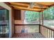 Screened porch featuring wooded view, wooden floor, and railing at 5207 Shawn Ln, Stone Mountain, GA 30088