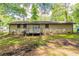 View of a brick house backyard with a wooden deck at 1105 Buckhurst Dr, Atlanta, GA 30349