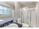 Bathroom with a shower, commode, and window for ample natural light at 1105 Buckhurst Dr, Atlanta, GA 30349