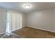 Neutral bedroom featuring a sliding glass door, plush carpeting, and neutral paint at 1105 Buckhurst Dr, Atlanta, GA 30349