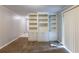 Bedroom featuring built-in bookshelves, plush carpeting, and a sliding glass door at 1105 Buckhurst Dr, Atlanta, GA 30349