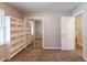 Bedroom view with bookshelf, mirrored closet, and open doorway to a connecting space at 1105 Buckhurst Dr, Atlanta, GA 30349