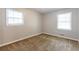 Neutral bedroom featuring two windows offering ample natural light and plush, neutral carpeting at 1105 Buckhurst Dr, Atlanta, GA 30349