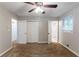 Bedroom featuring plush carpet, neutral paint, ceiling fan, and access to a bathroom at 1105 Buckhurst Dr, Atlanta, GA 30349