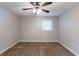 Bedroom featuring a ceiling fan, plush carpeting, and a large window at 1105 Buckhurst Dr, Atlanta, GA 30349