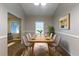 Elegant dining room featuring a long wooden table with seating for eight and a modern aesthetic at 1105 Buckhurst Dr, Atlanta, GA 30349